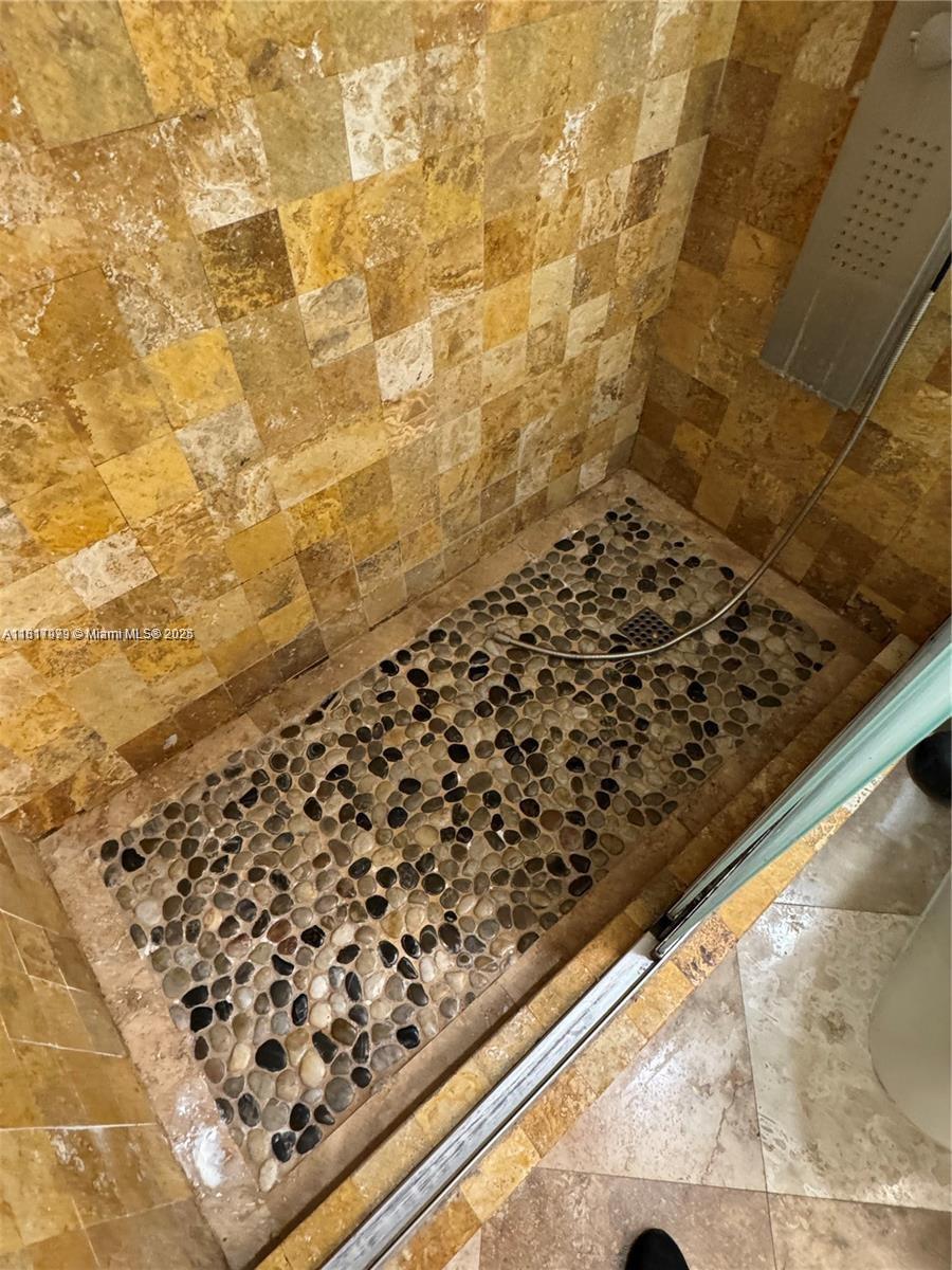 5091 Northwest 7th Street, Unit 615 Miami, FL 33126 - Photo 30 of 40 a bathroom with a shower