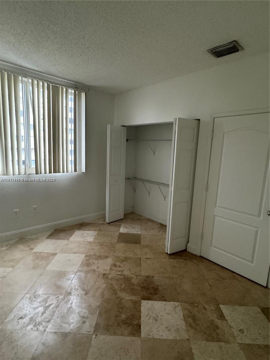5091 Northwest 7th Street, Unit 615 Miami, FL 33126 - Photo 31 of 40 a view of an empty room with staircase