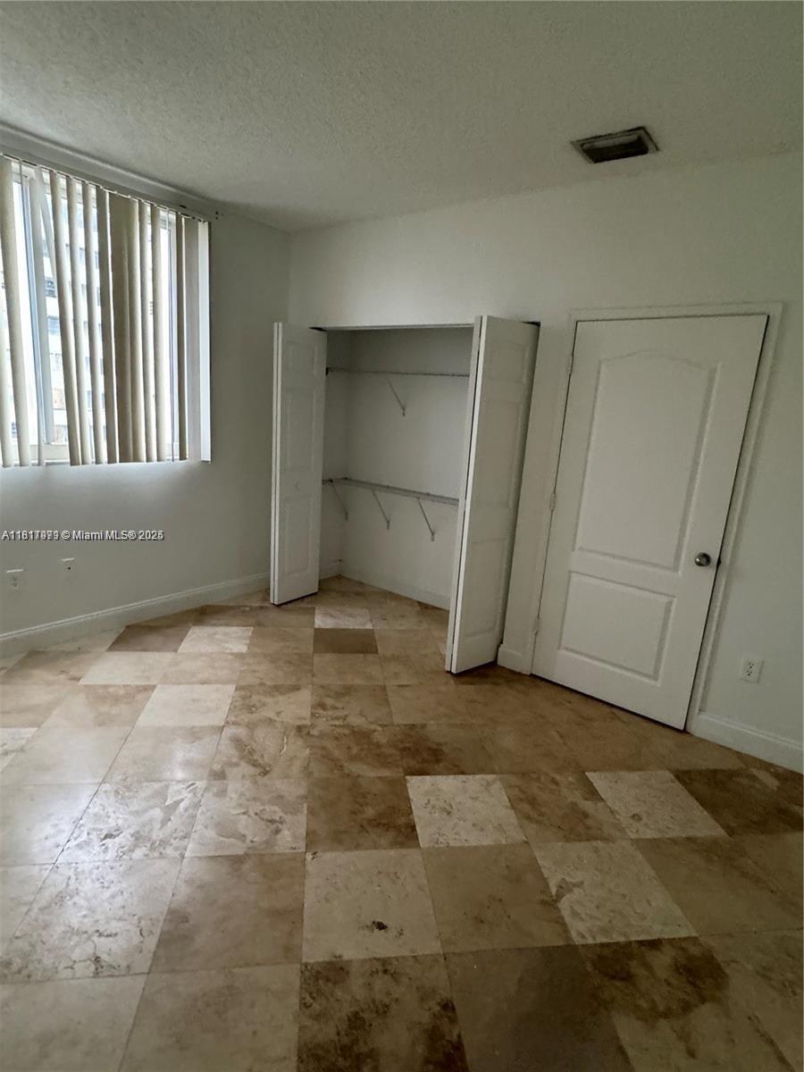 5091 Northwest 7th Street, Unit 615 Miami, FL 33126 - Photo 32 of 40 a view of an empty room with closet