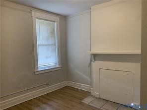 3119 A 4th Avenue Richmond, VA 23222 - Photo 9 of 15 a view of an empty room with wooden floor and a window