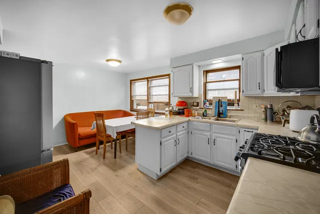 a kitchen with furniture a window and a sink