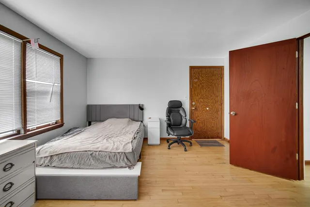 a bedroom with a bed and a dresser in it