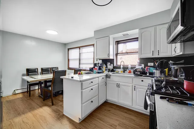 a kitchen with a sink cabinets and window