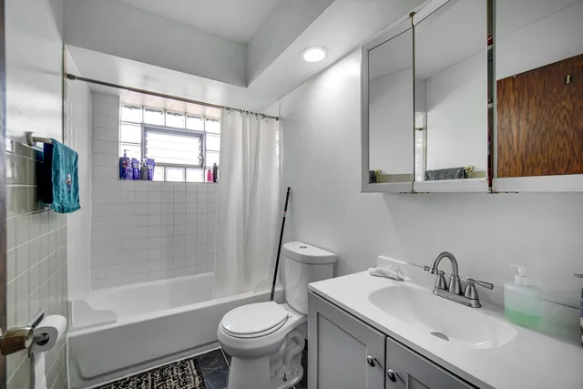 a bathroom with a sink toilet a mirror and shower
