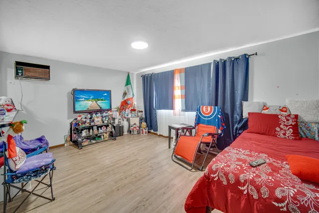 a bed room with two beds and a chair