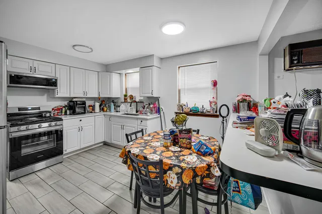 a kitchen with a table and chairs in it