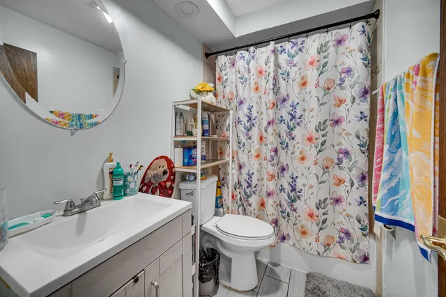 a bathroom with a sink mirror vanity and toilet