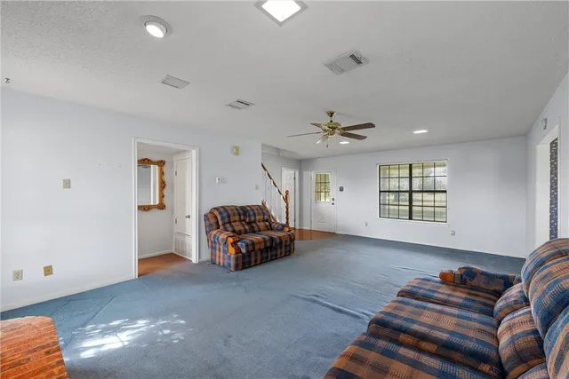 a view of livingroom with furniture and staircase