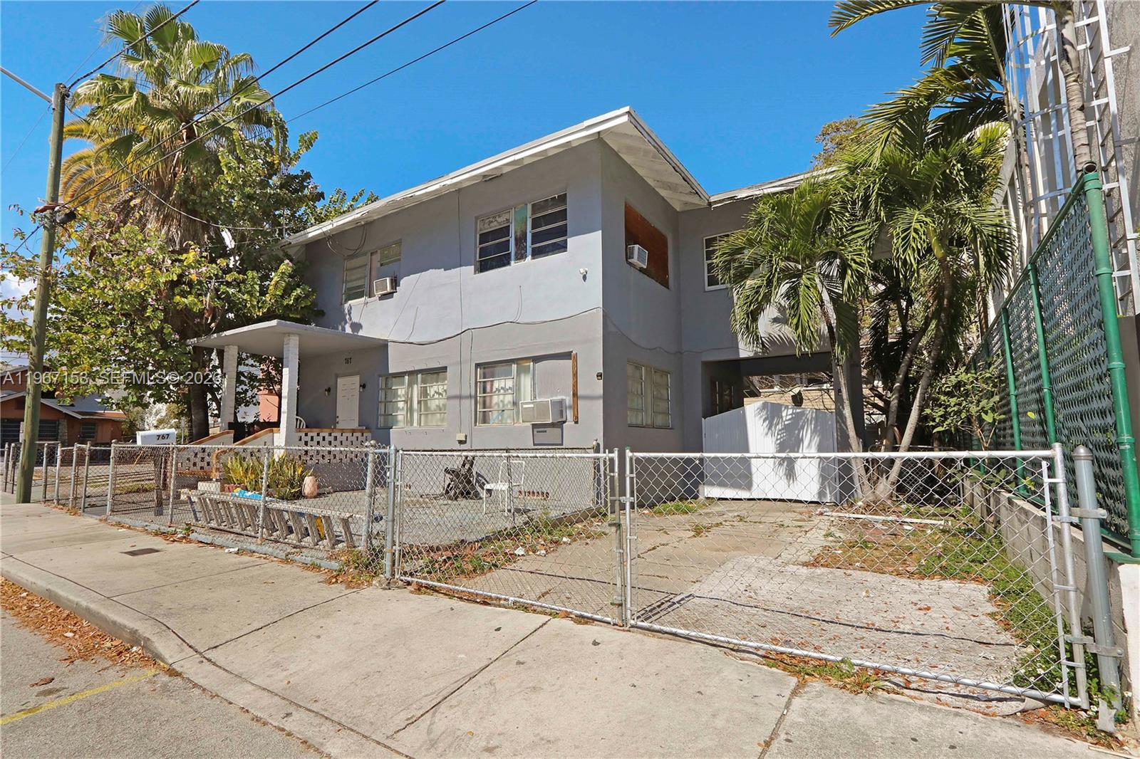 767 Southwest 2nd Street Miami, FL 33130 - Photo 6 of 22 a front view of a house with a basket ball court
