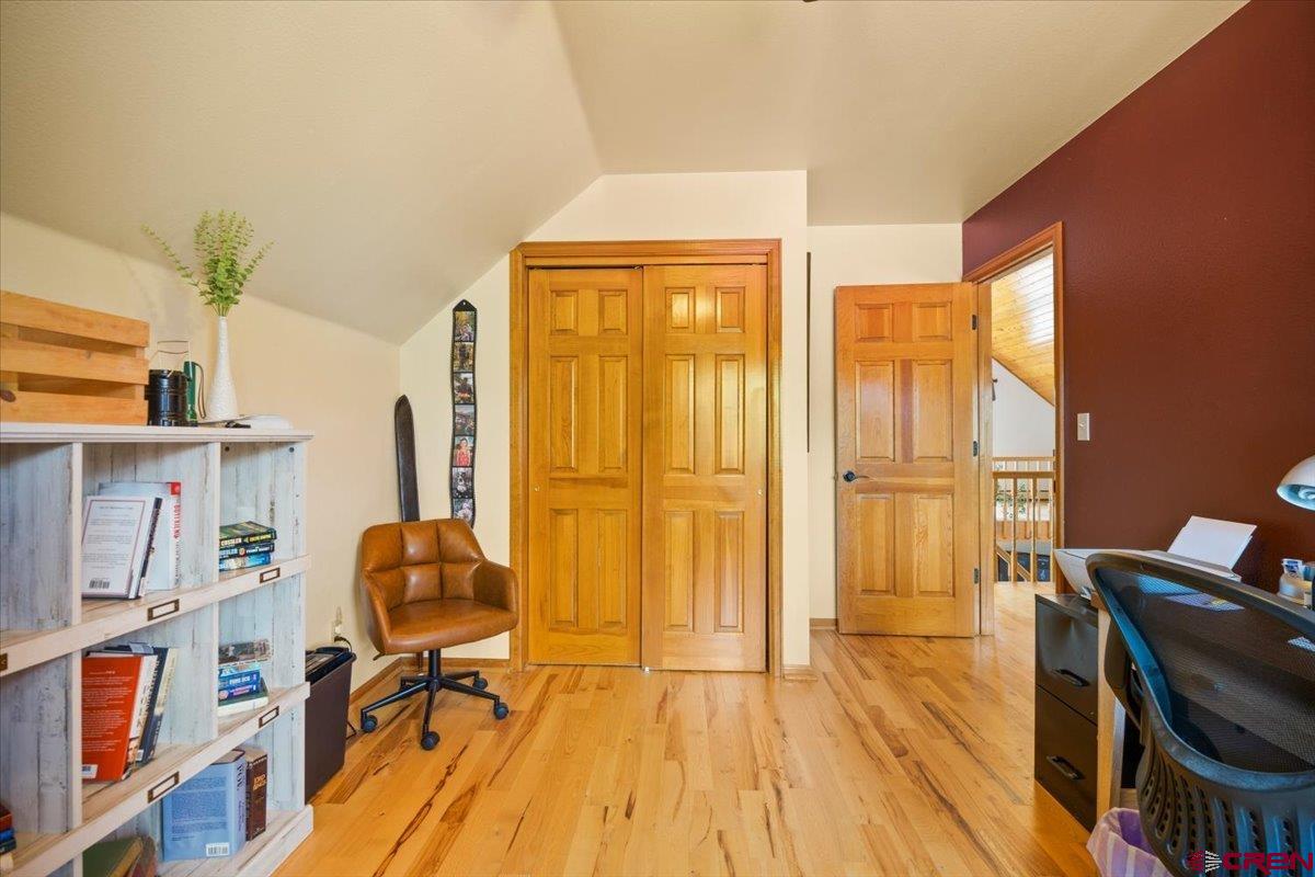 19016 Pinon Drive Cedaredge, CO 81413 - Photo 32 of 45 a view of a workspace with furniture and wooden floor