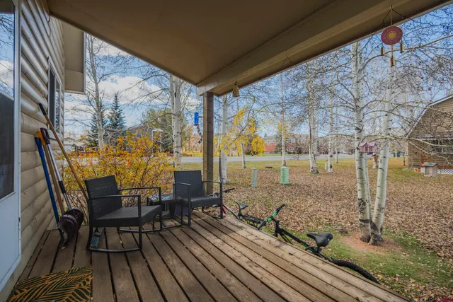 a view of a porch with furniture and a yard