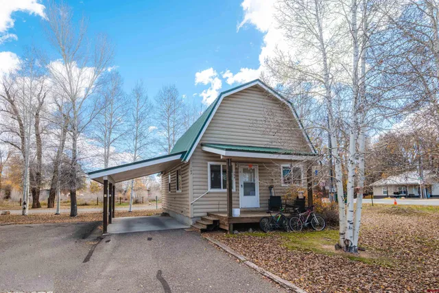 a front view of a house with trees