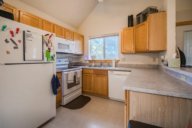 a kitchen with stainless steel appliances a refrigerator sink and white cabinets