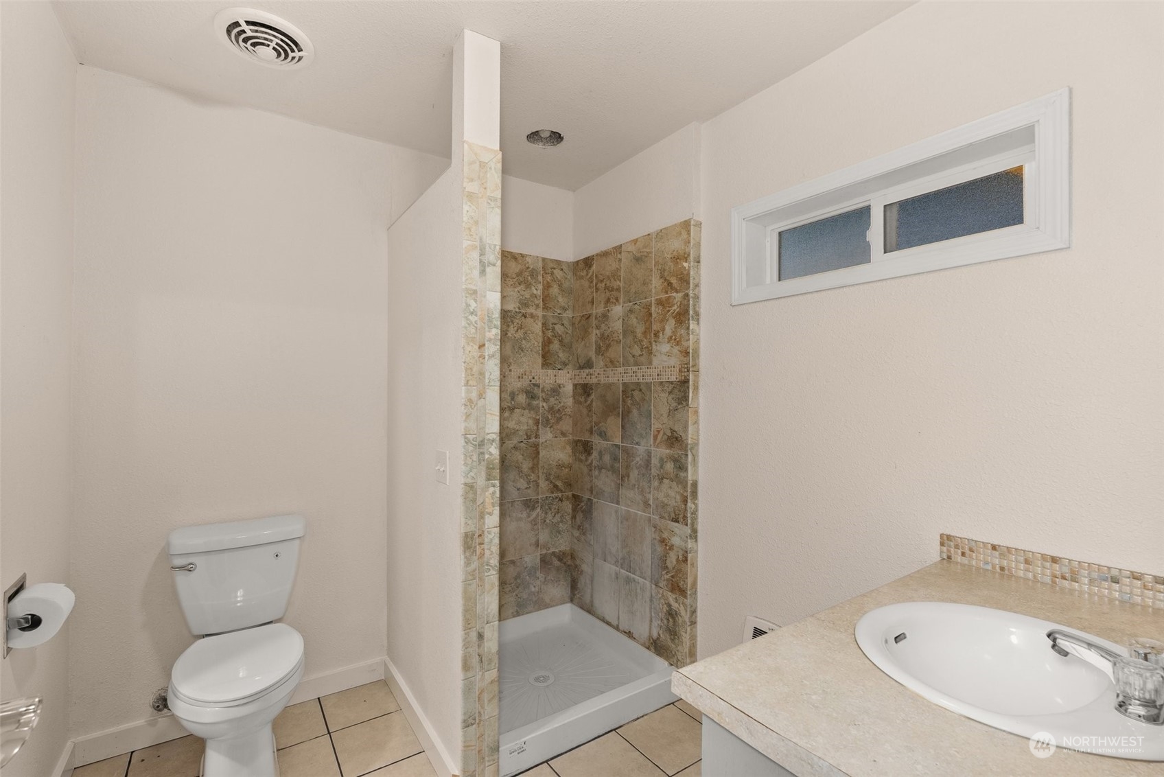 2131 Stuart Street Raymond, WA 98577 - Photo 12 of 25 a bathroom with a toilet and shower