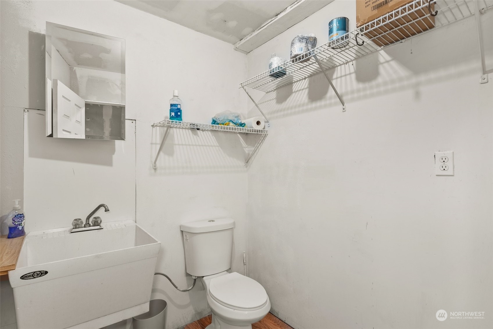 2131 Stuart Street Raymond, WA 98577 - Photo 16 of 25 a white toilet sitting next to a bathroom sink and tub