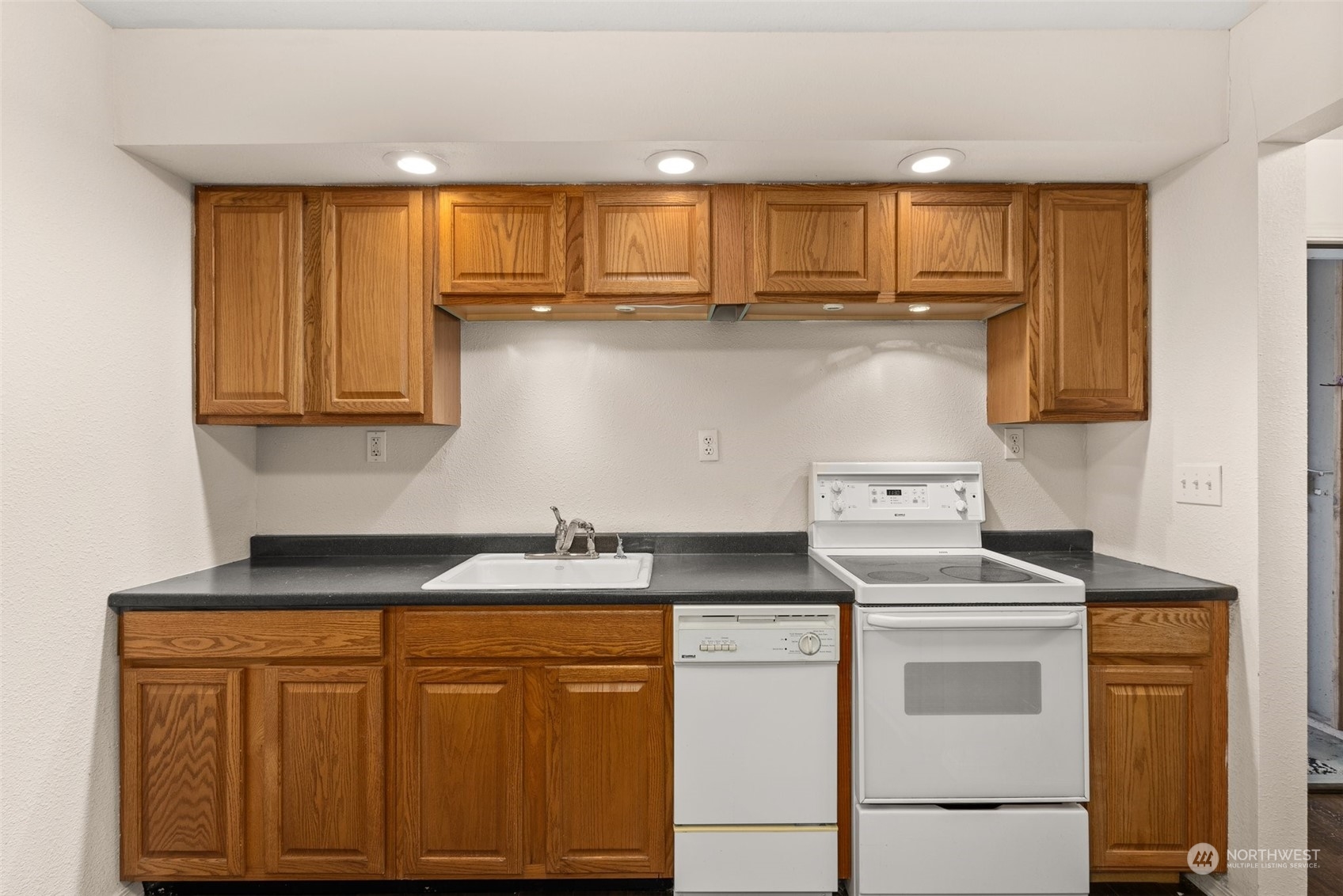 2131 Stuart Street Raymond, WA 98577 - Photo 5 of 25 a kitchen with stainless steel appliances granite countertop a stove a sink and a microwave