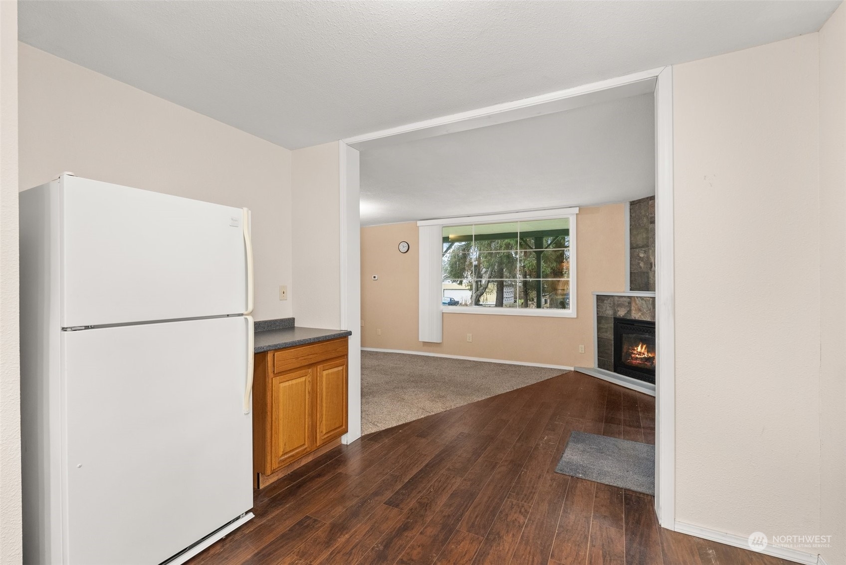 2131 Stuart Street Raymond, WA 98577 - Photo 6 of 25 an empty room with wooden floor and cabinet