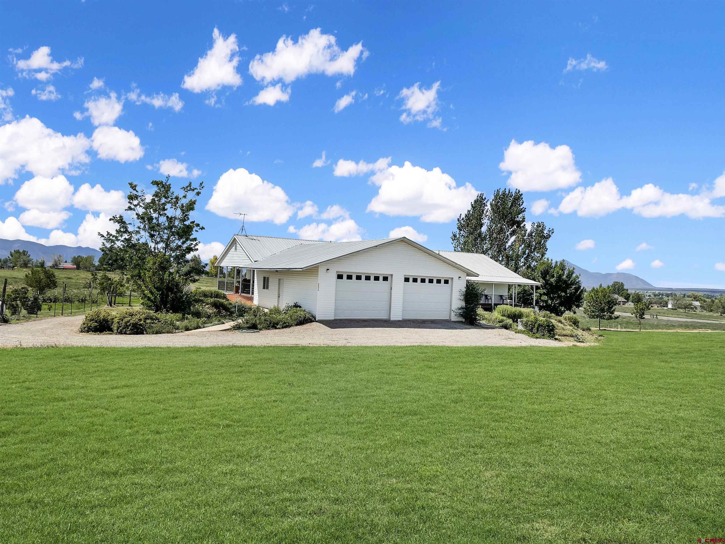 25970 Rd P Cortez, CO 81321 - Photo 1 of 20 a view of a house with a yard and a garage