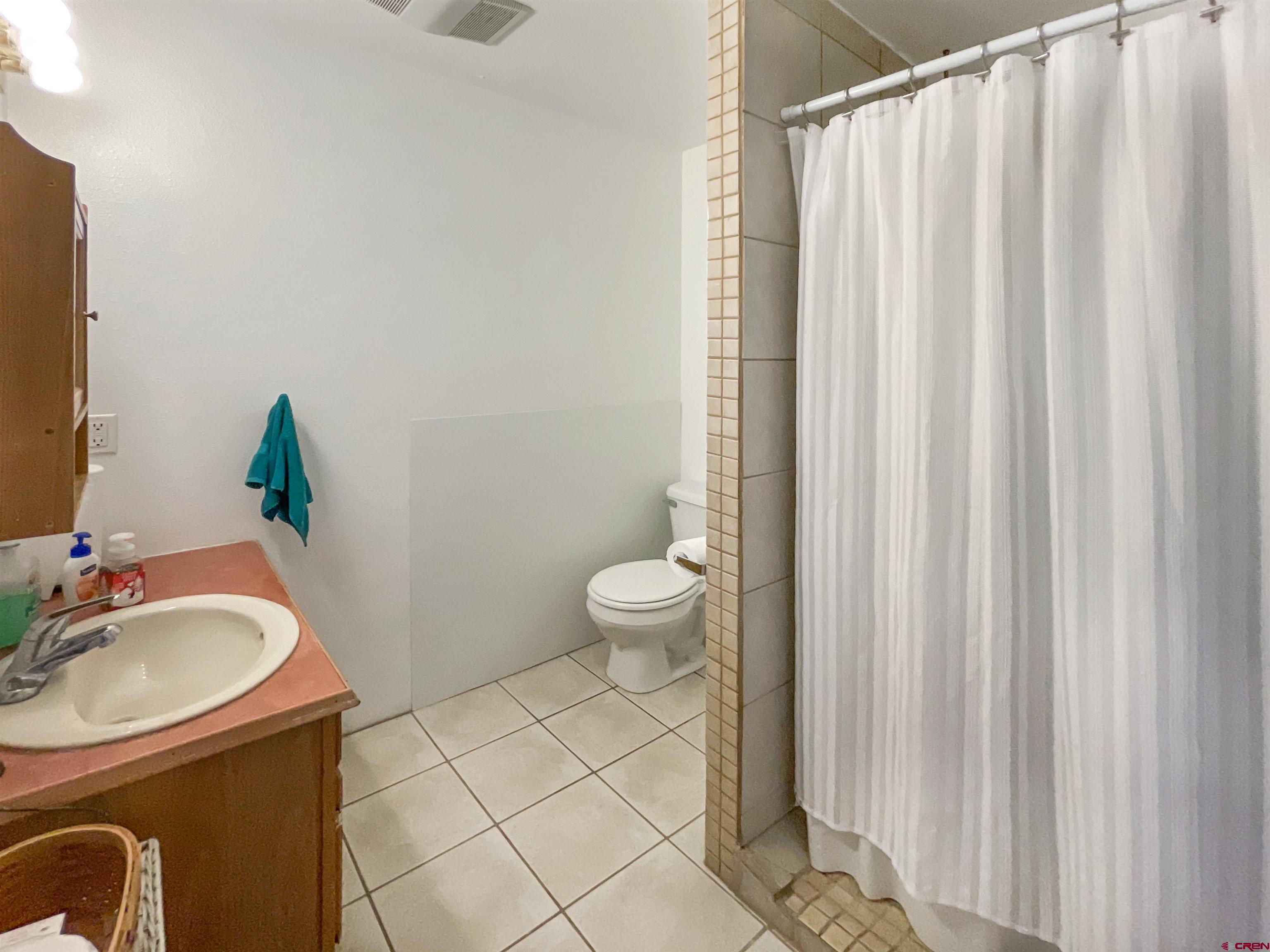 25970 Rd P Cortez, CO 81321 - Photo 11 of 20 a bathroom with a sink toilet and shower