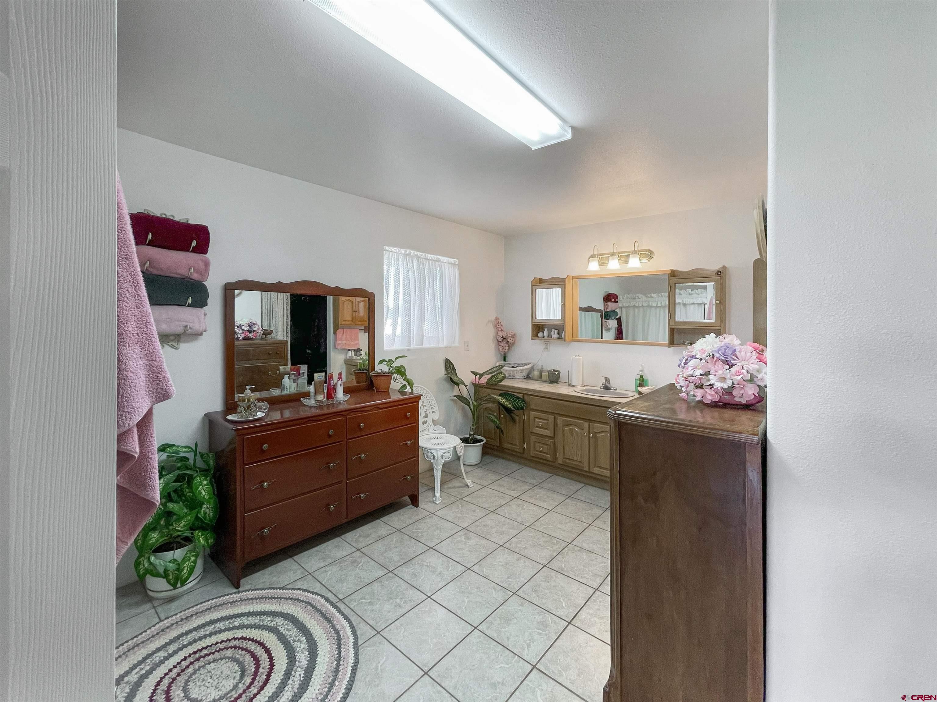 25970 Rd P Cortez, CO 81321 - Photo 13 of 20 a large bathroom with a sink mirror and a bath tub