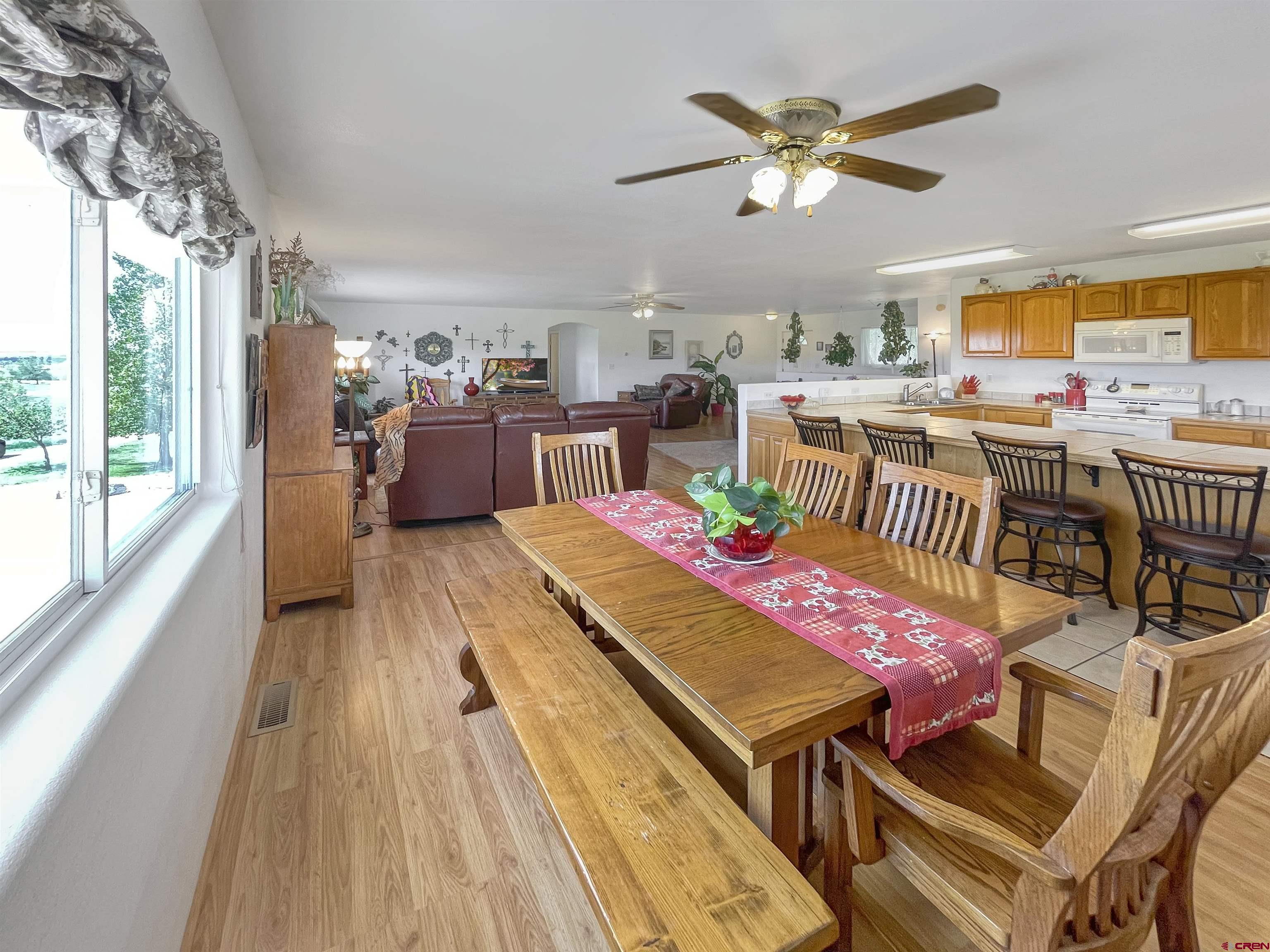 25970 Rd P Cortez, CO 81321 - Photo 6 of 20 a dining room with furniture and a floor to ceiling window