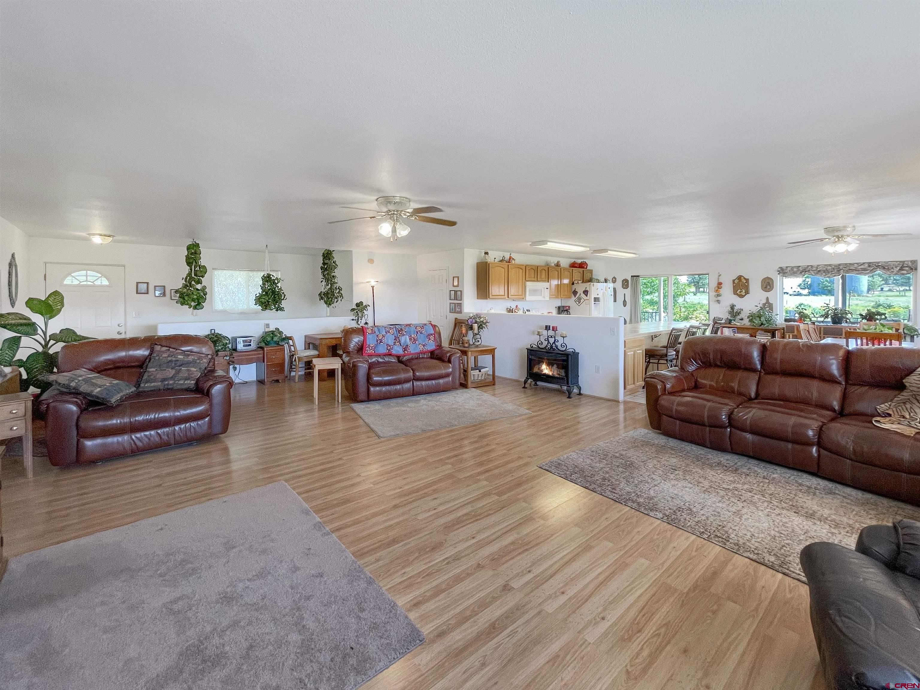 25970 Rd P Cortez, CO 81321 - Photo 7 of 20 a living room with furniture and a dining table with kitchen view