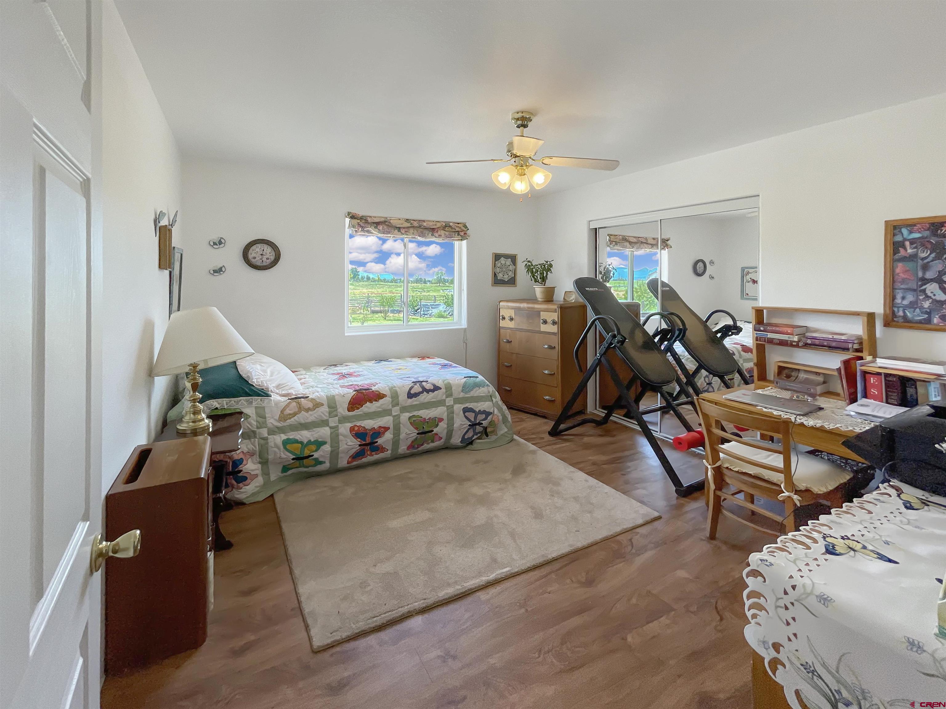 25970 Rd P Cortez, CO 81321 - Photo 9 of 20 a bedroom with furniture and a wooden floor