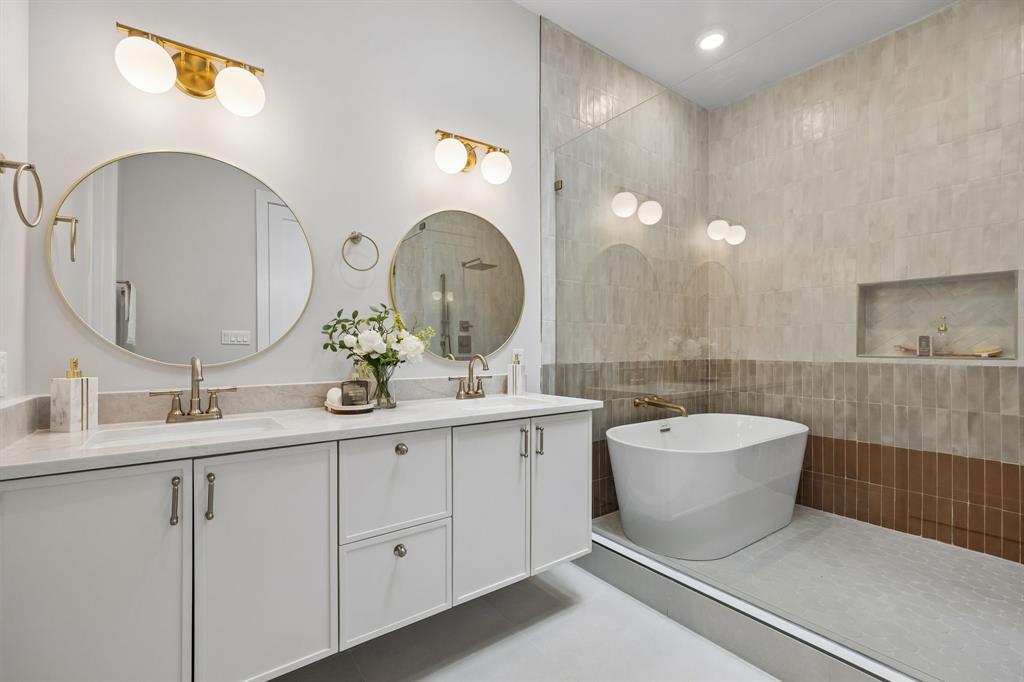 4615 Rusk Avenue Dallas, TX 75204 - Photo 16 of 25 a bathroom with a double vanity sink mirror and bathtub