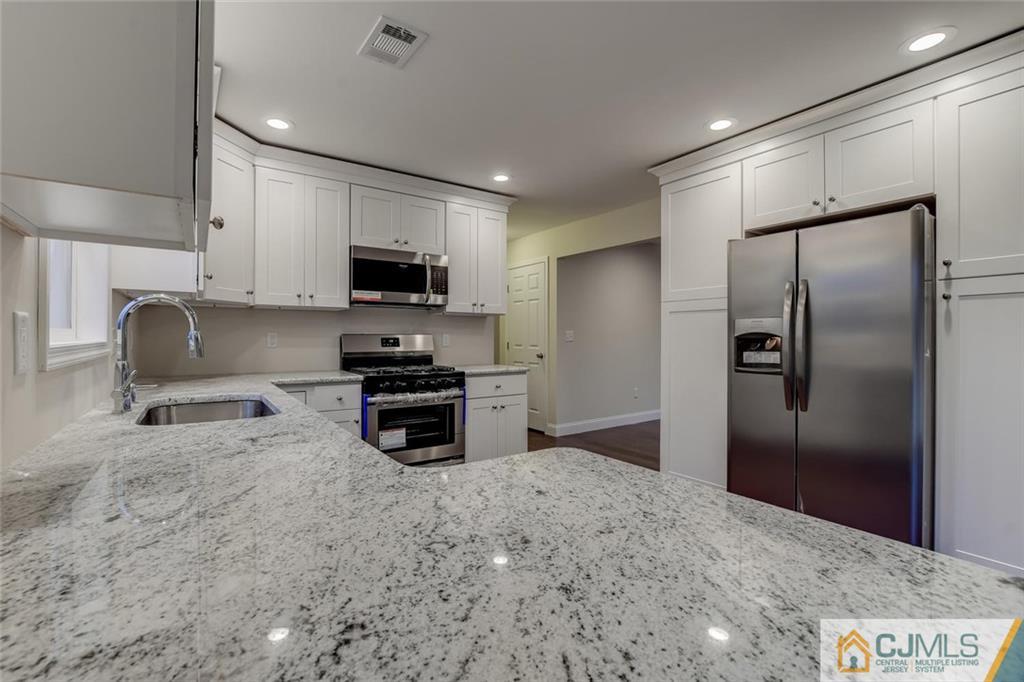 41 Emerson Road Somerset, NJ 08873 - Photo 14 of 25 a kitchen with stainless steel appliances granite countertop a refrigerator and a sink