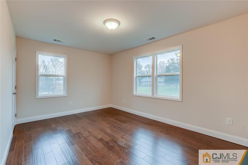 41 Emerson Road Somerset, NJ 08873 - Photo 15 of 25 an empty room with wooden floor and windows