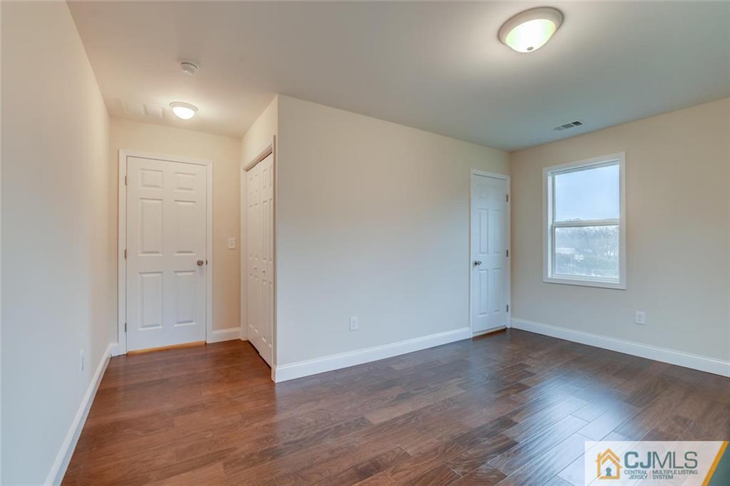 41 Emerson Road Somerset, NJ 08873 - Photo 16 of 25 an empty room with wooden floor and windows