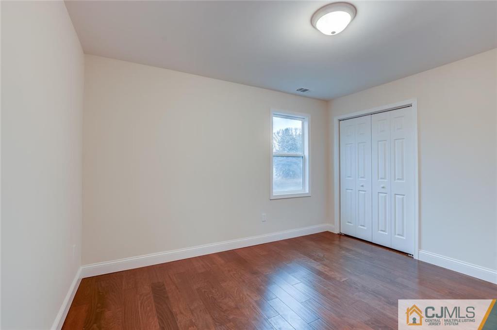 41 Emerson Road Somerset, NJ 08873 - Photo 20 of 25 an empty room with wooden floor and windows