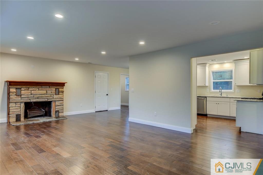 41 Emerson Road Somerset, NJ 08873 - Photo 3 of 25 a view of an empty room with a fireplace and a window