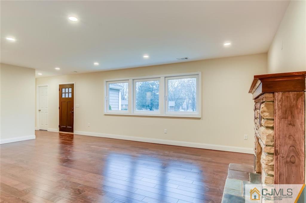 41 Emerson Road Somerset, NJ 08873 - Photo 5 of 25 an empty room with wooden floor and a window