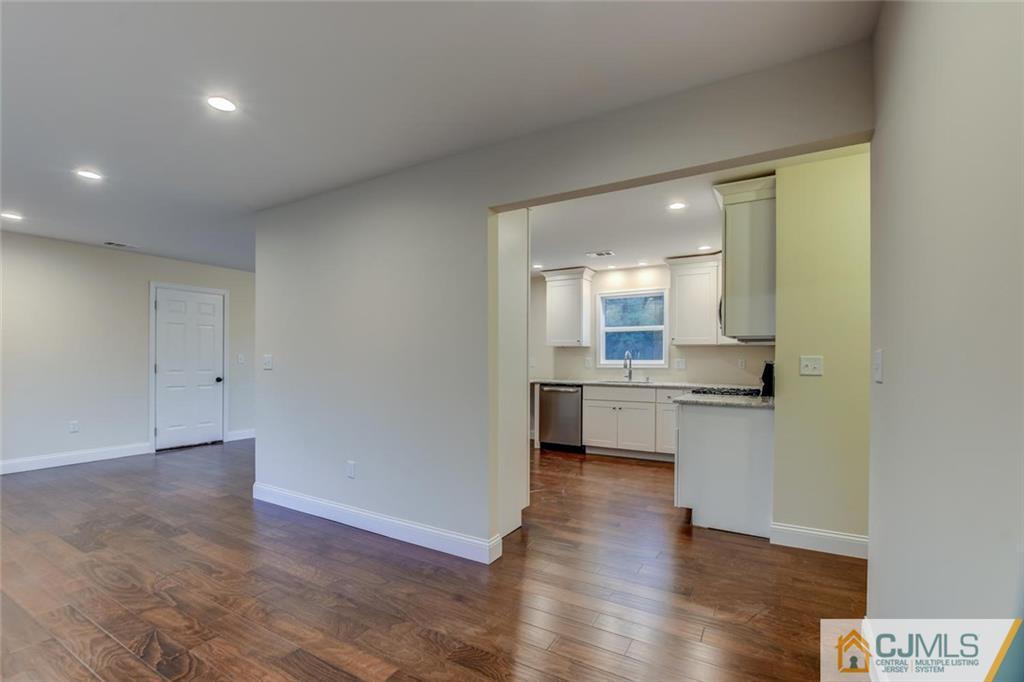 41 Emerson Road Somerset, NJ 08873 - Photo 6 of 25 a open kitchen with white cabinets and wooden floor