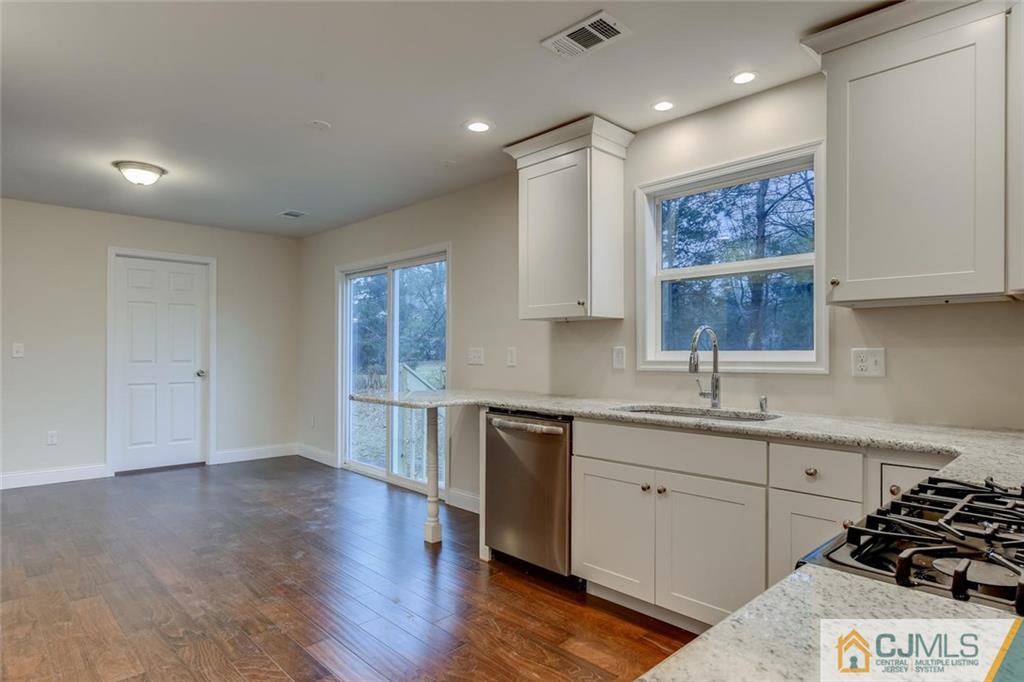 41 Emerson Road Somerset, NJ 08873 - Photo 9 of 25 a kitchen with a sink stove and cabinets