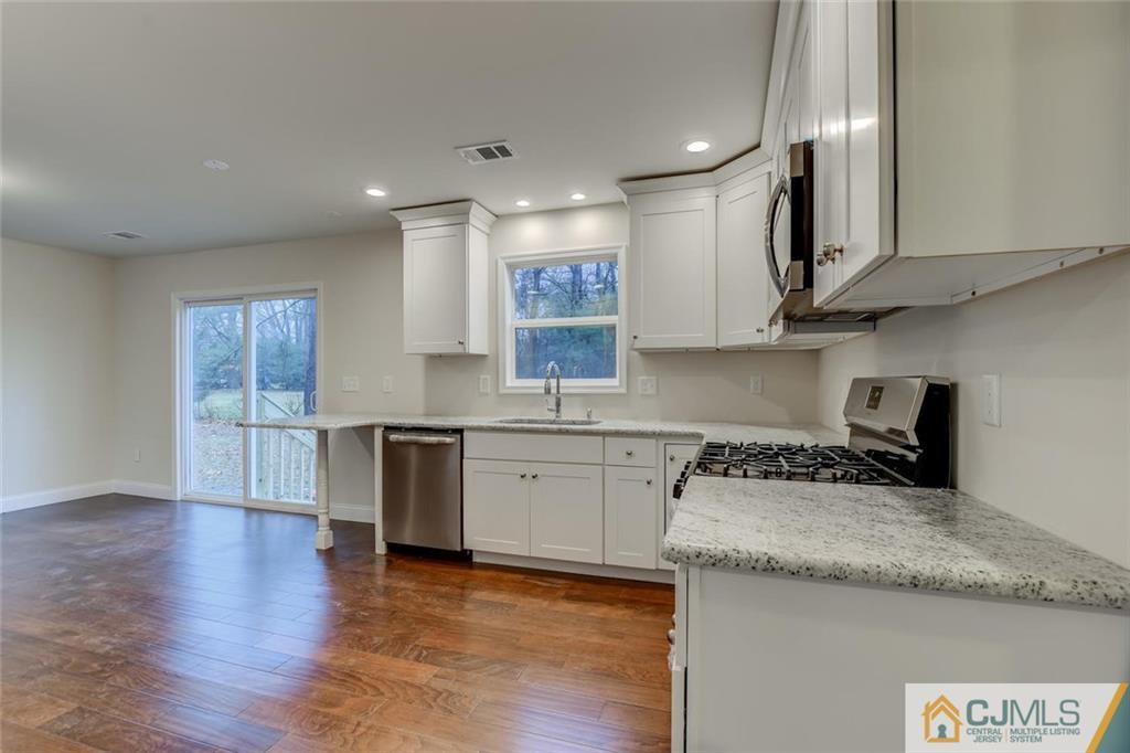 41 Emerson Road Somerset, NJ 08873 - Photo 10 of 25 a kitchen with granite countertop a sink and cabinets