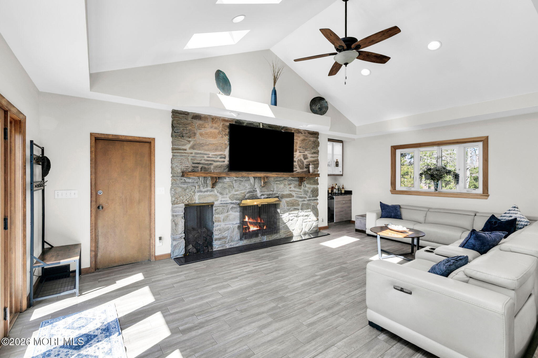12 Crest Drive Colts Neck, NJ 07722 - Photo 13 of 77 a living room with furniture a fireplace and a flat screen tv