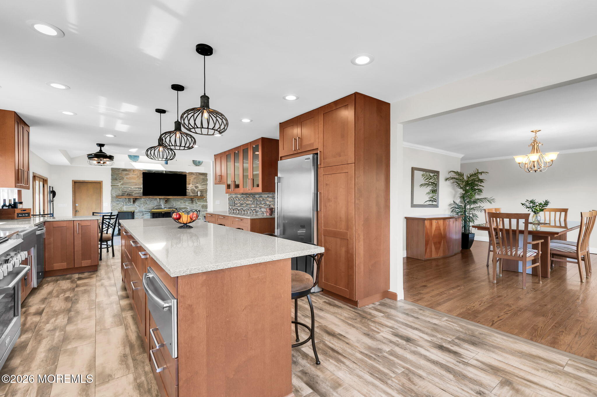 12 Crest Drive Colts Neck, NJ 07722 - Photo 23 of 77 a kitchen with stainless steel appliances kitchen island granite countertop a refrigerator a stove a microwave oven a dining table and chairs with wooden floor
