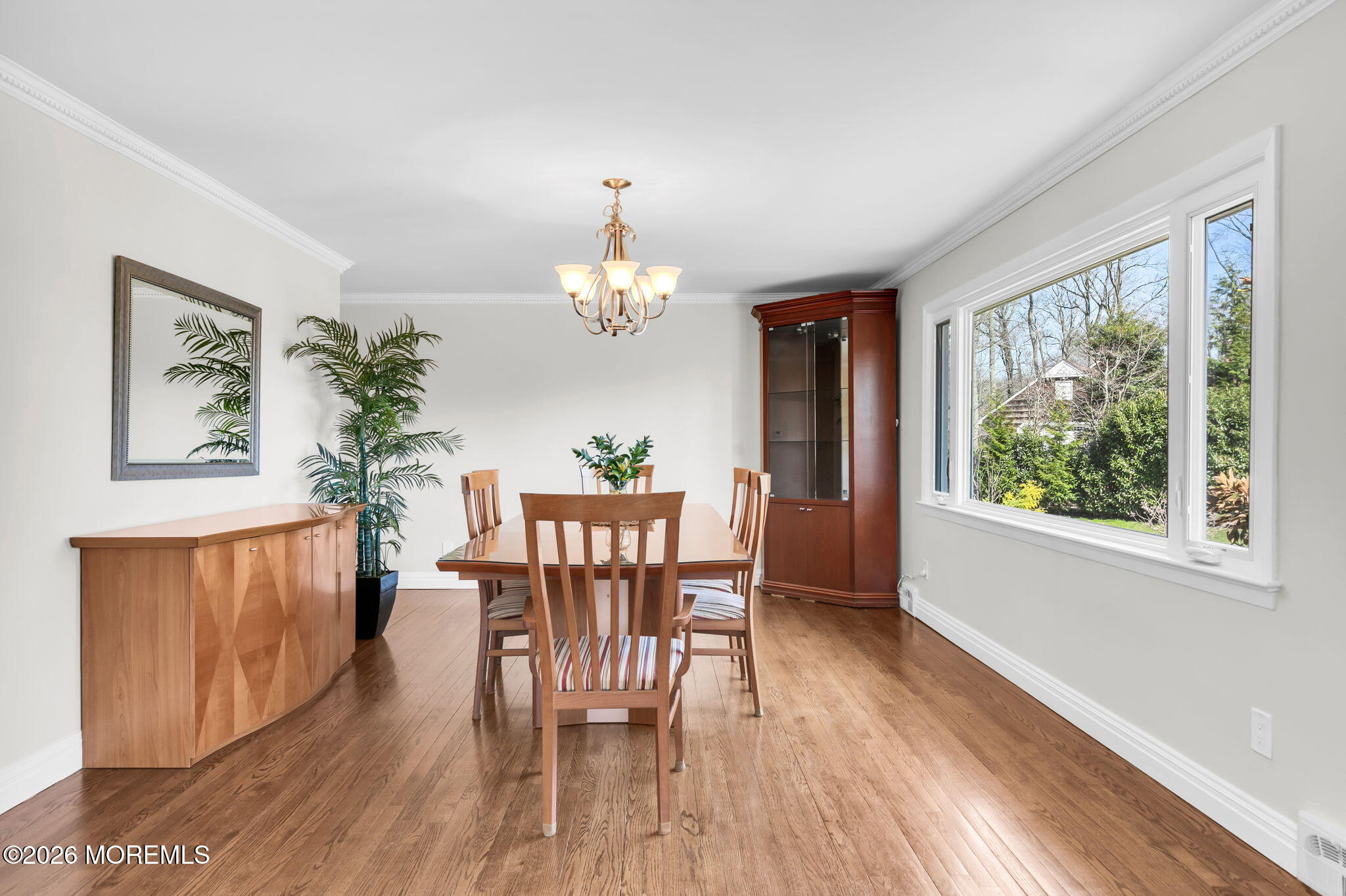 12 Crest Drive Colts Neck, NJ 07722 - Photo 28 of 77 a dining room with furniture a large window and wooden floor