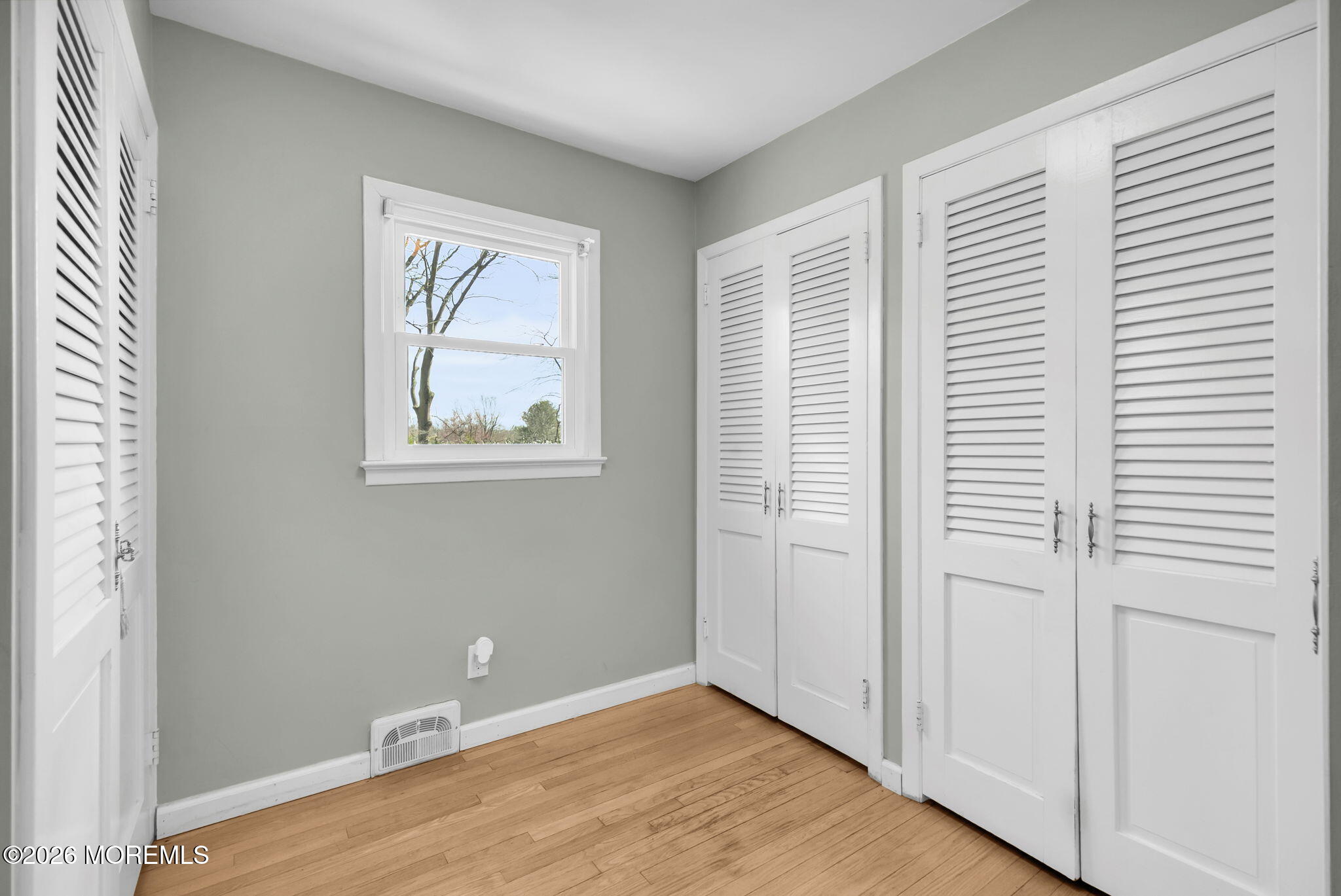 12 Crest Drive Colts Neck, NJ 07722 - Photo 32 of 77 an empty room with wooden floor and windows