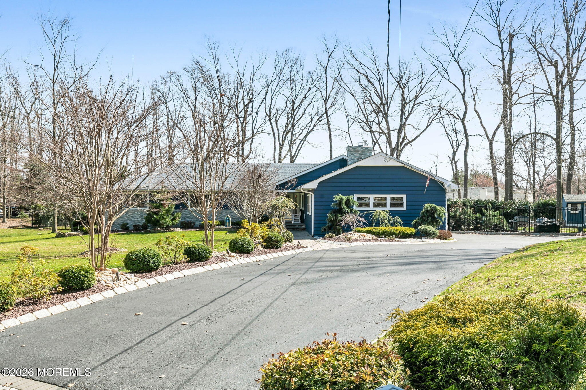 12 Crest Drive Colts Neck, NJ 07722 - Photo 61 of 77 a front view of a house with a yard and potted plants