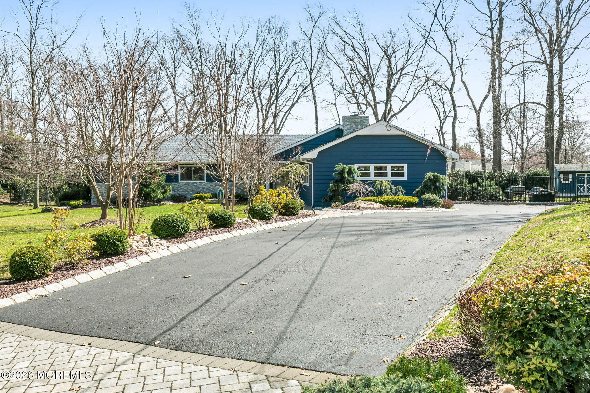 12 Crest Drive Colts Neck, NJ 07722 - Photo 62 of 77 a front view of a building with garden and trees