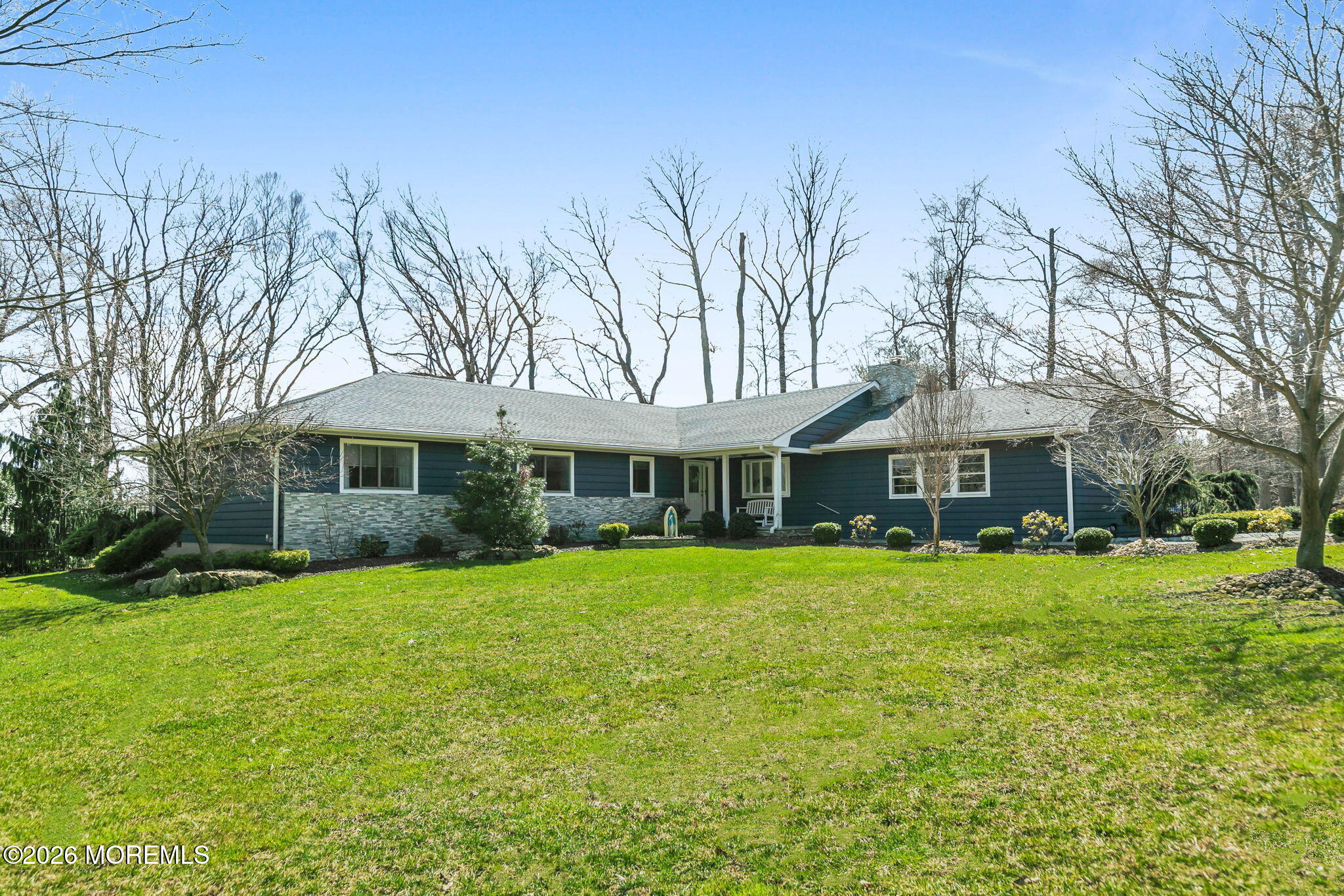 12 Crest Drive Colts Neck, NJ 07722 - Photo 66 of 77 a front view of a house with a yard and trees