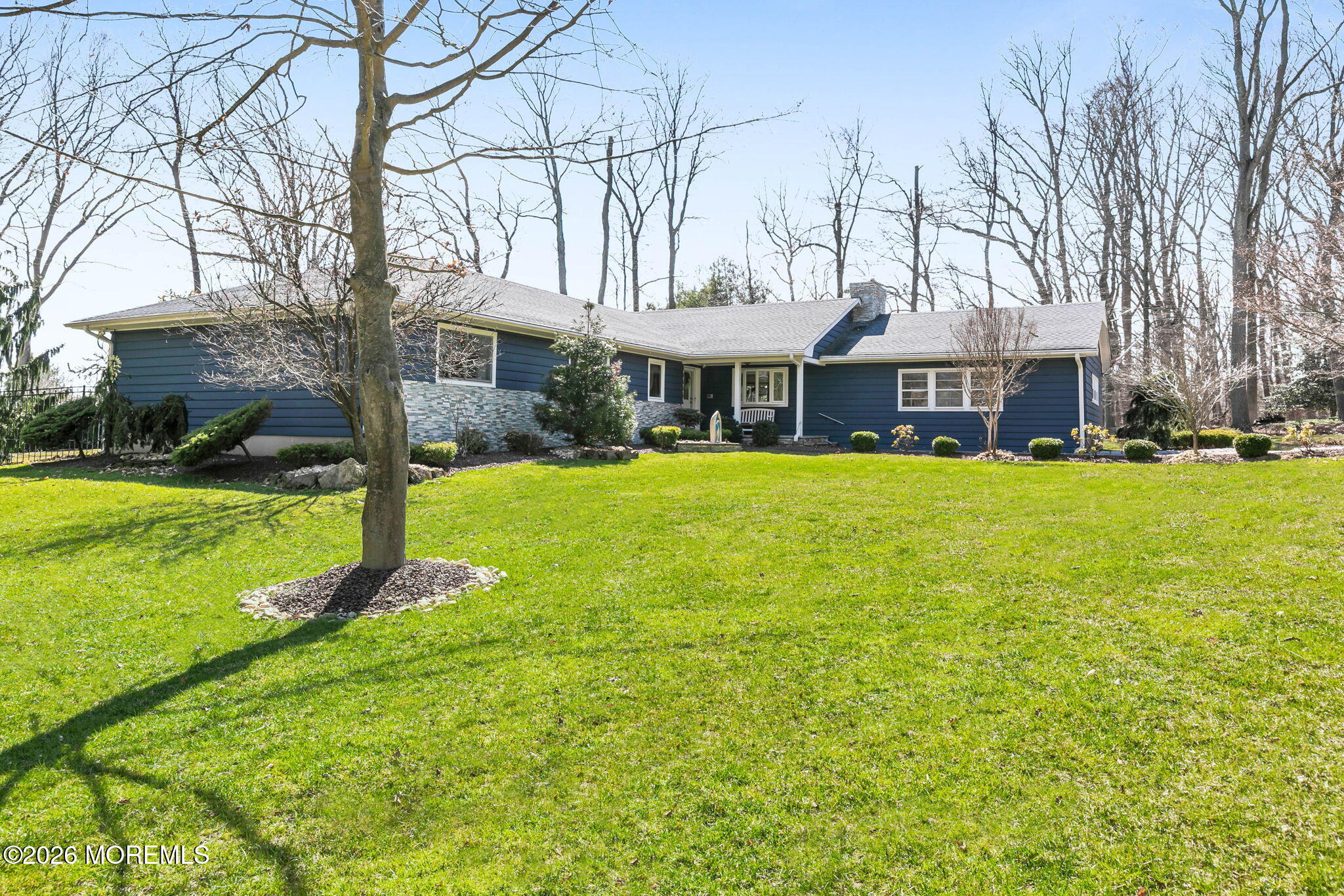 12 Crest Drive Colts Neck, NJ 07722 - Photo 67 of 77 a view of a white house with a big yard and potted plants and large trees