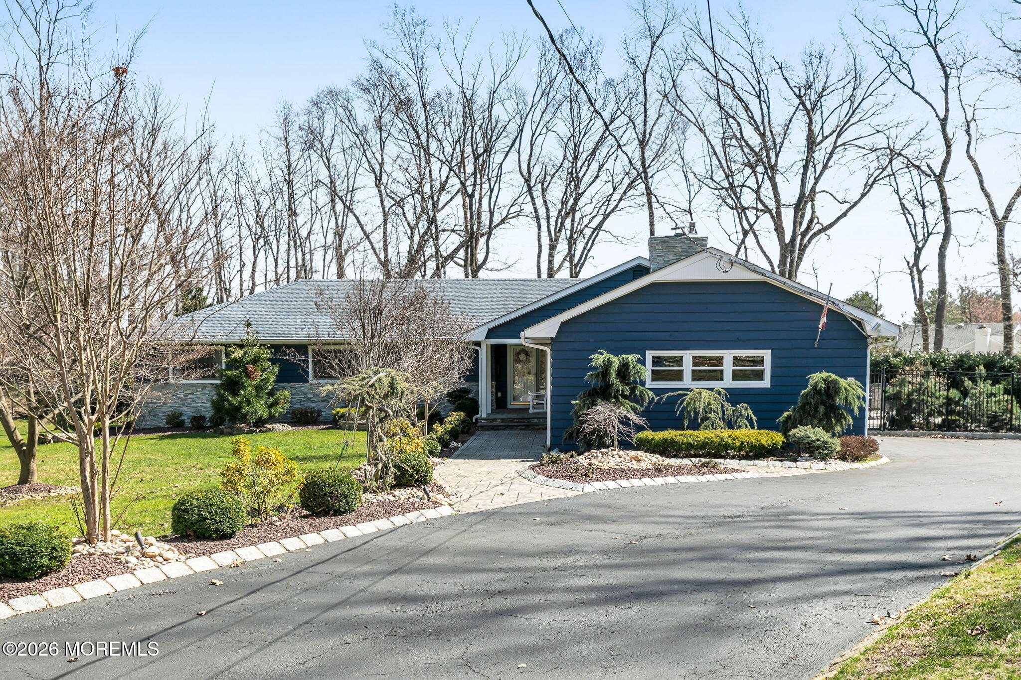 12 Crest Drive Colts Neck, NJ 07722 - Photo 7 of 77 a front view of a house with a yard and potted plants
