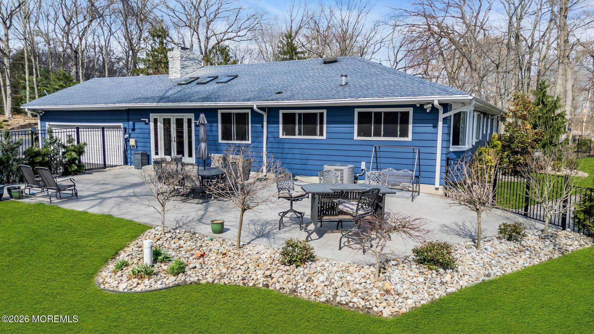 12 Crest Drive Colts Neck, NJ 07722 - Photo 73 of 77 a view of house with table and chairs under an umbrella