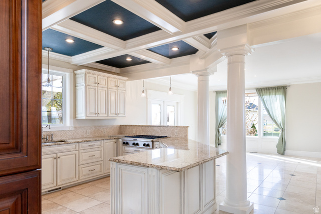 434 Cardon Ridge Drive Smithfield, UT 84335 - Photo 3 of 59 Kitchen with a peninsula, crown molding, light tile patterned flooring, light stone counters, and hanging light fixtures