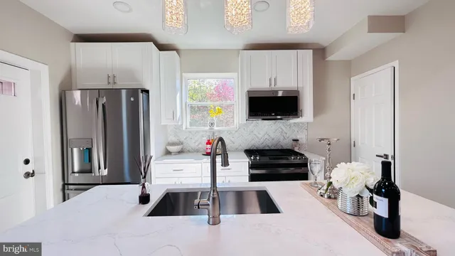 a kitchen with a refrigerator and a stove top oven