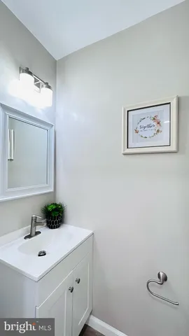 a bathroom with a sink mirror and vanity